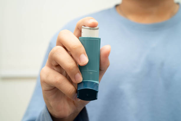 istock Asthma and chronic obstructive pulmonary disease COPD, Asian young man using metered dose inhaler MDI. 2195612401