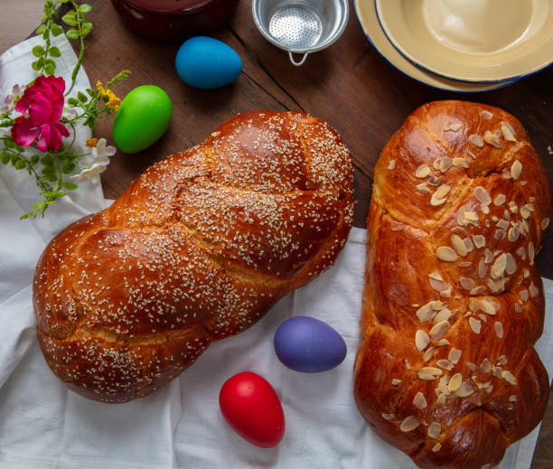 istock Easter sweet bread, two tsoureki braids and colorful Easter eggs on the table 2195613335