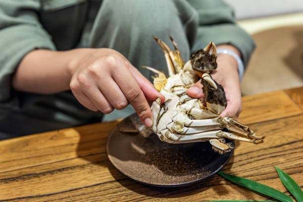A woman's hand showing a peeled hairy crab