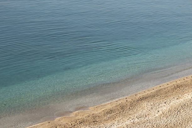 Background of blue sea, white sand and small pebbles. High quality photo