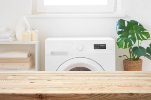 istock Empty wooden table mock-up for design in blurred laundry room 2195618785
