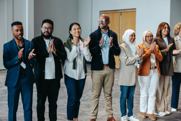 istock Diverse group of skilled colleagues clapping during a training session, showcasing teamwork and success in a professional setting. 2195618845