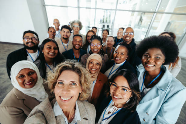 istock Multiethnic corporate team taking a group selfie together inside an office building 2195618972