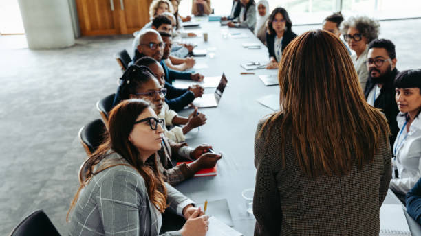 istock Manager leading business meeting with diverse team at large conference table 2195619156