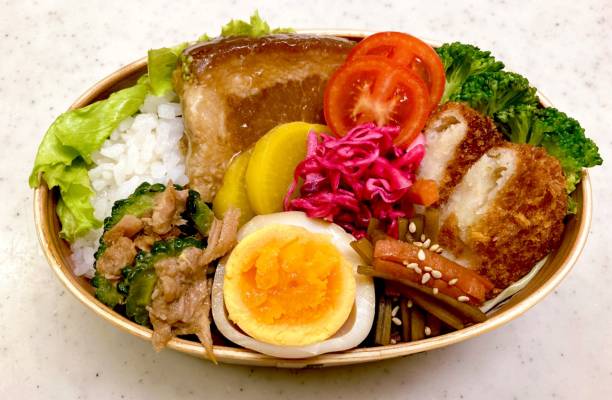 istock A traditional Korean dosirak, beautifully arranged with rice, assorted banchan, and savory proteins. Balanced and visually inviting, it’s a portable meal packed with vibrant flavors. 2195619363