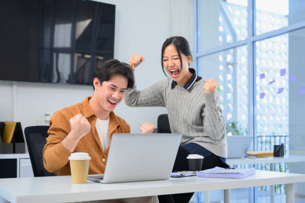 istock Cheerful colleagues expressing excitement and success after completing a task 2195619701