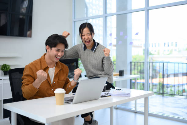 istock Cheerful colleagues expressing excitement and success after completing a task 2195619723