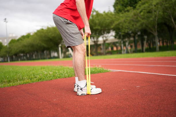 istock Unrecognizable man using resistance elastic band to exercise outdoors 2195622923