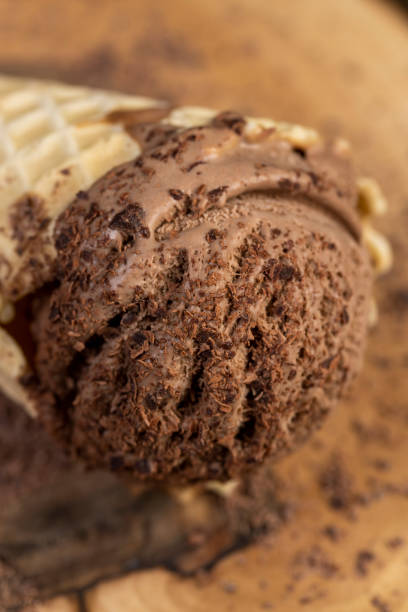 istock chocolate ice cream in a cone on a board 2195623532