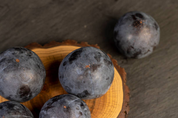 istock ripe purple plum on the table 2195623567