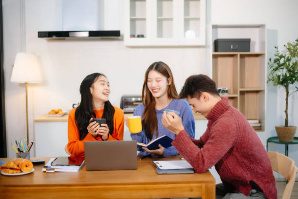 istock Teamwork and creativity with young adults collaborating on laptops and tablets 2195626000