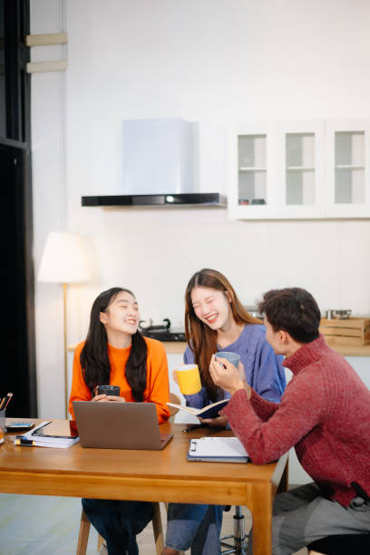 istock Teamwork and creativity with young adults collaborating on laptops and tablets 2195626023
