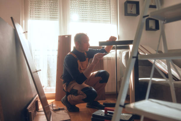 istock Carpenter working and assembling furniture in a new apartment. 2195627828
