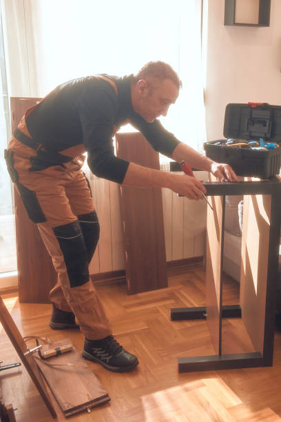 istock Carpenter working and assembling furniture in a new apartment. 2195628364