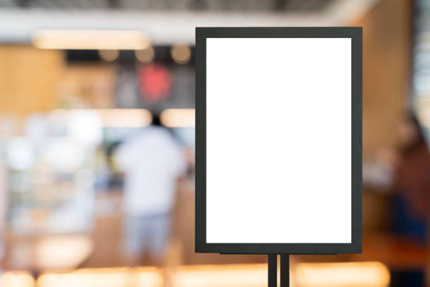 istock Mockup white poster with black frame stand in front of blur restaurant cafe background for show or present 2195628521