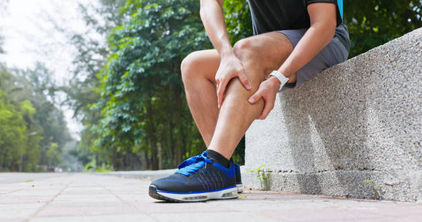 istock asian man sporting calf cramping 2195632746