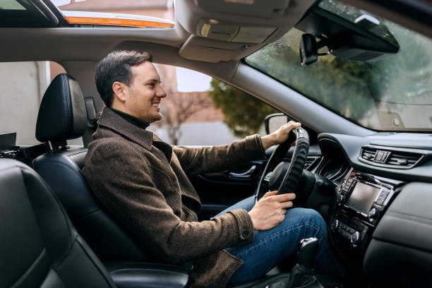 istock Side view of man driving car 2195632791