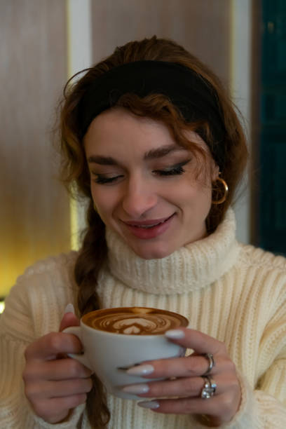 Enjoying a beautifully crafted cup of latte art in a cozy cafe during the morning hours
