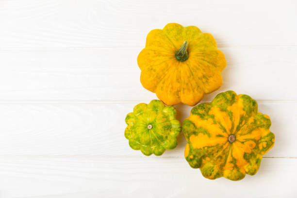 istock Pattypan zucchini on a textured kitchen table. squash. Fresh organic pattypan squashes on background. Vegan. Farmer's Market. Patisson. Space for text. Copy space. 2195633347