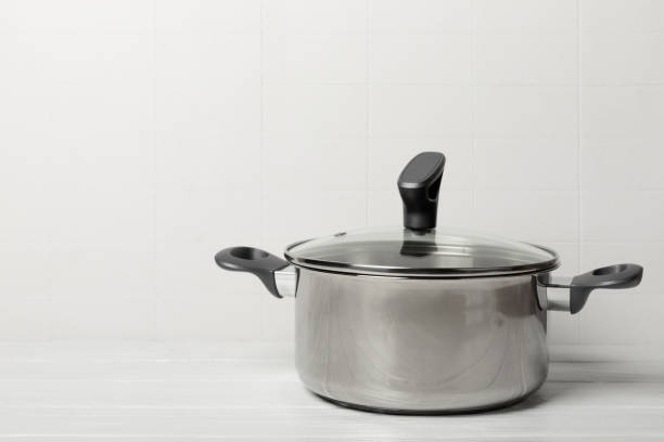 istock Stainless steel saucepan on light kitchen background. Modern saucepan. Kitchenware. Cooking pot. Cooking concept. Mockup. Space for text. Copy space. 2195633885