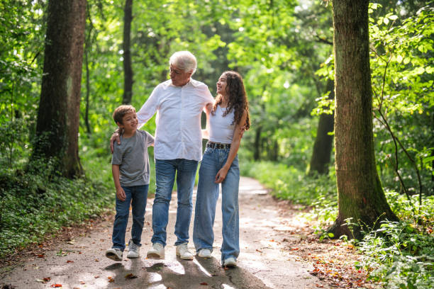 istock Joyful Walk Amongst Trees with Grandfather 2195634595