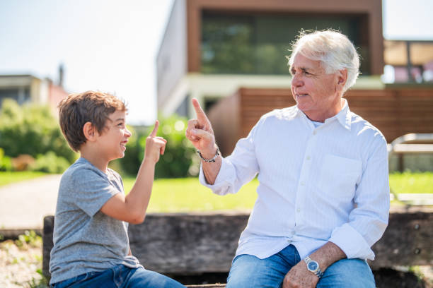 Portrait of a senior man pointing at something interesting to his family over white background