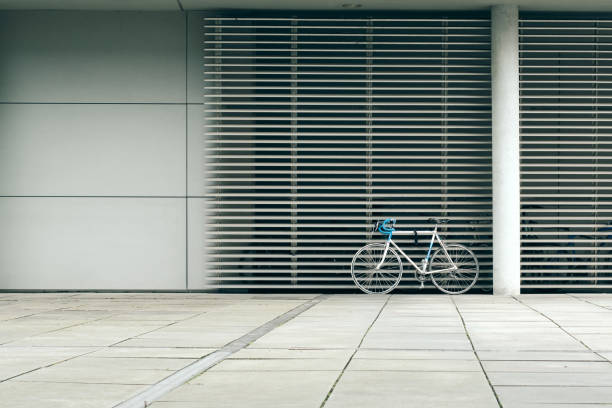 lonely bicycle in front of window facade with blinds