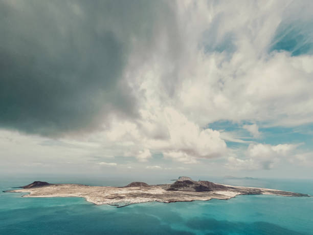 Aerial view of an island with dramatic cloud formation