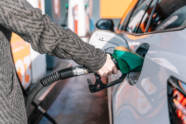 istock Driver pumping gasoline into car at gas station 2195638046