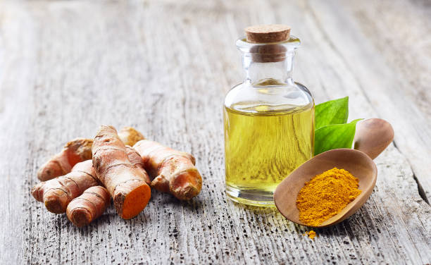 istock Turmeric root with curcuma essential oil on wooden board 2195639812