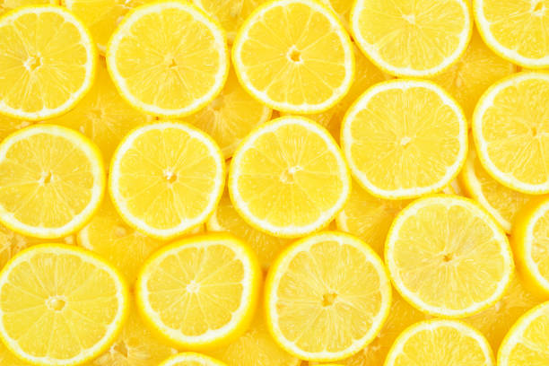 istock A slices of fresh juicy yellow lemons.  Texture background, pattern. 2195642499