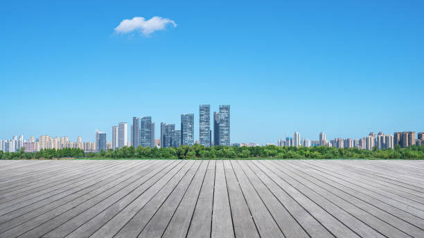 istock Empty wooden viewing platform with modern urban skyline and sunny blue sky background 2195642863