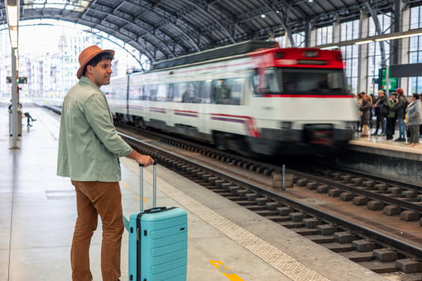 istock Tourist looking at arriving train in station 2195643055