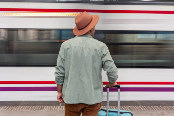 istock Tourist watching a moving train at the railway station 2195643227