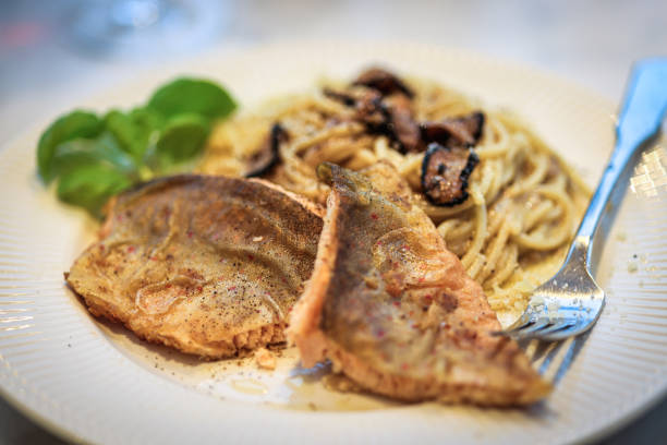 Fried lake char with spaghetti and truffle.