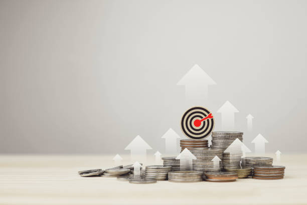 istock Stack of silver coins,  and target board with rising arrow. Investment management concepts 2195644399
