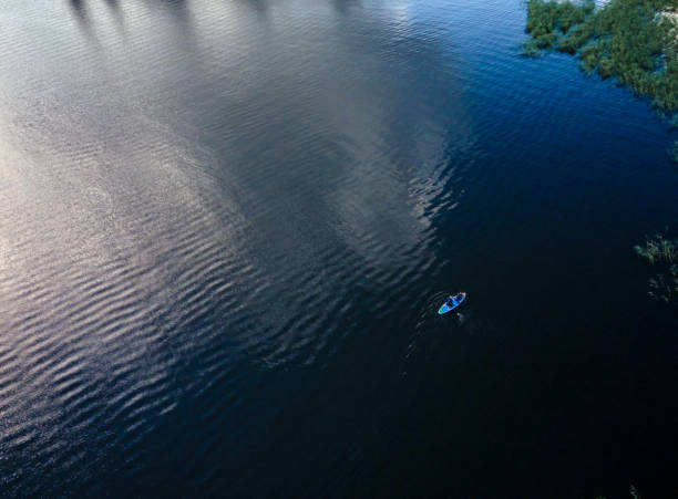istock Aerial View of paddleboarder Exploring Serene Lake Waters 2195644484