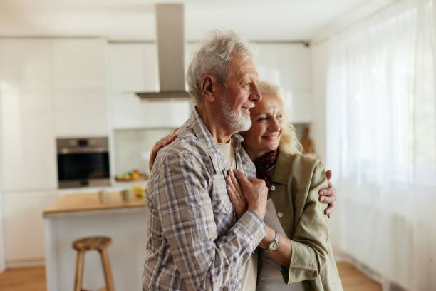 istock Happy senior couple day dreaming at home. 2195648900