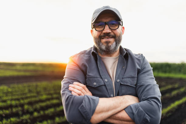istock Confident Farmer Standing in a Field During Sunset 2195649002