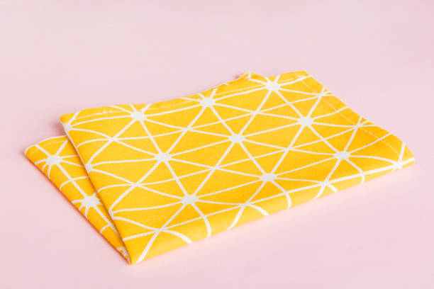 istock top view with yellow empty kitchen napkin isolated on table background. Folded cloth for mockup with copy space, Flat lay. Minimal style 2195649371