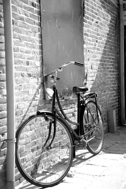 istock bicycle by the wall retro. bw 2195649476