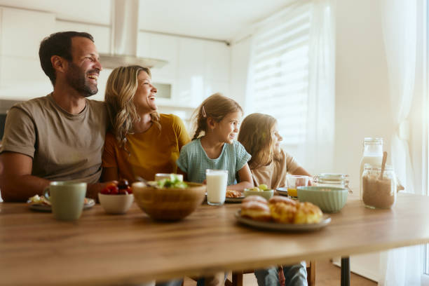 istock Happy family enjoying during breakfast in dining room. 2195650023