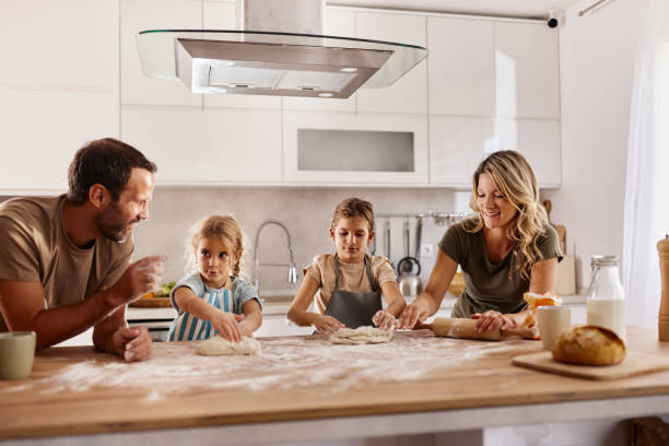 istock Happy family enjoying while making a cake at home. 2195650287
