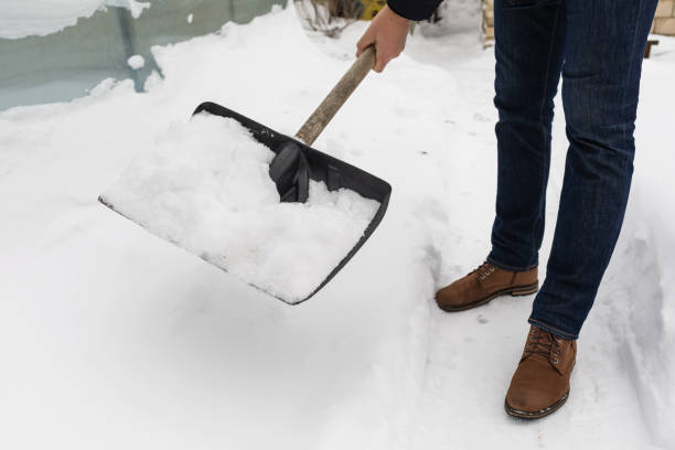 istock Man removing snow in yard with snow shovel 2195650435