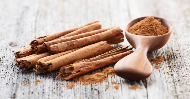 istock Cinnamon bark and powder on wooden background 2195651583