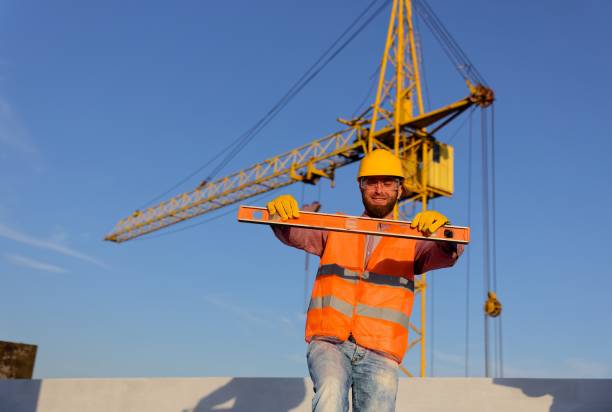 istock Construction manager and engineer discussing building project on site with crane in background 2195656181