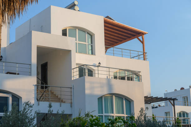 Modern coastal villa basking in evening sunlight with expansive view of tranquil surroundings