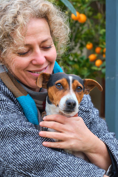 istock Woman embracing her jack russell terrier with love and affection 2195658799