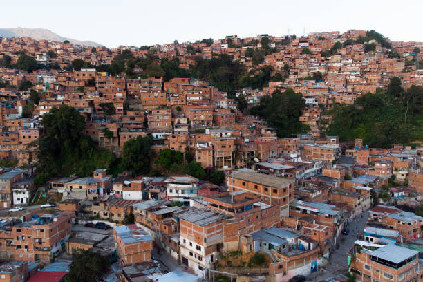 Aerial view of Caracas at sunset with the Petare neighborhood, the largest slum in Venezuela and latin america, with the Avila Mountain in the background.