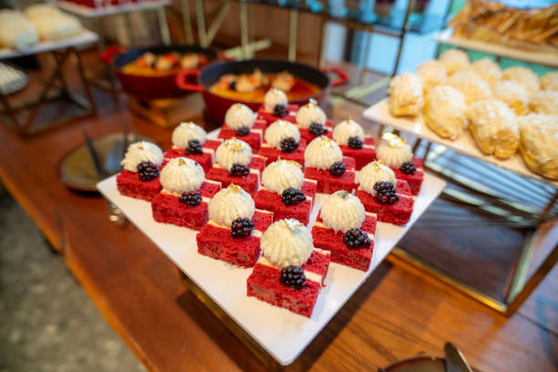 istock Elegance in Red: Bite-sized Red Velvet Cake Slices Ready to Tempt Palates at the Buffet Line 2195659533